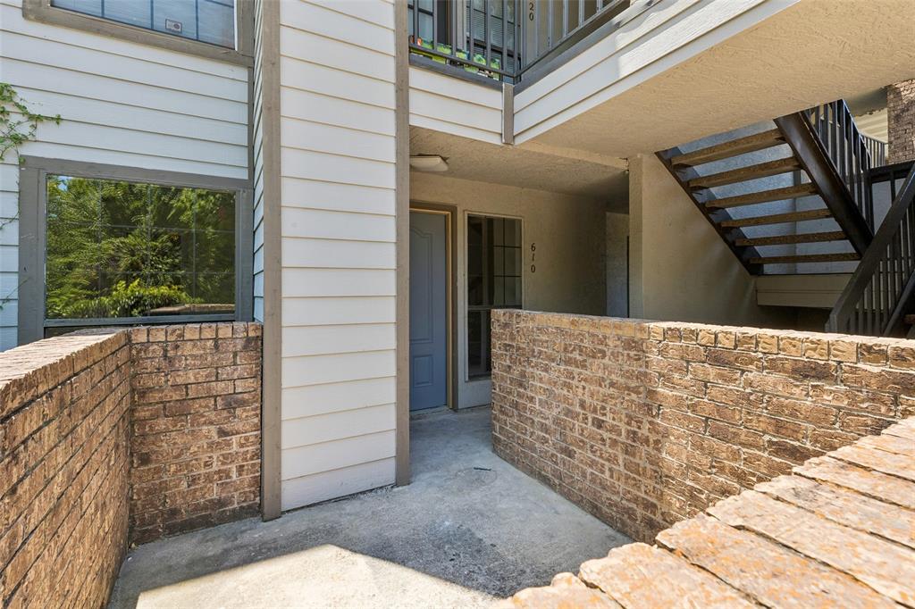 Private patio area featuring brick walls and concrete flooring Private patio area featuring brick walls and concrete flooring