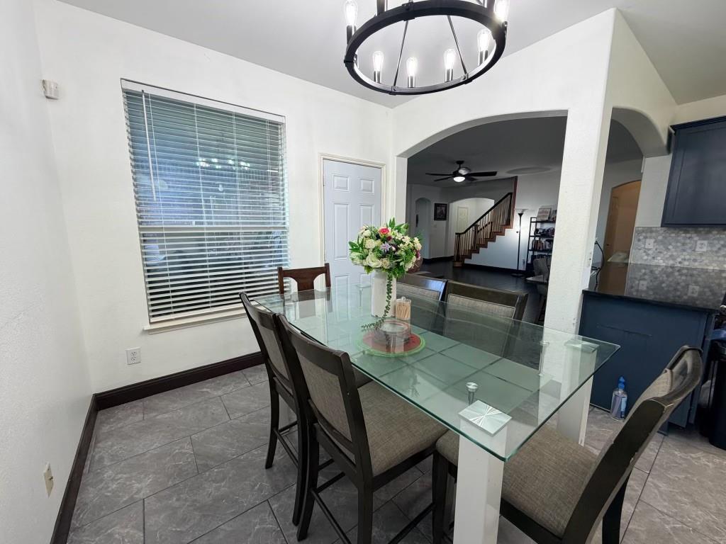 Dining area with tile flooring and a window with blinds