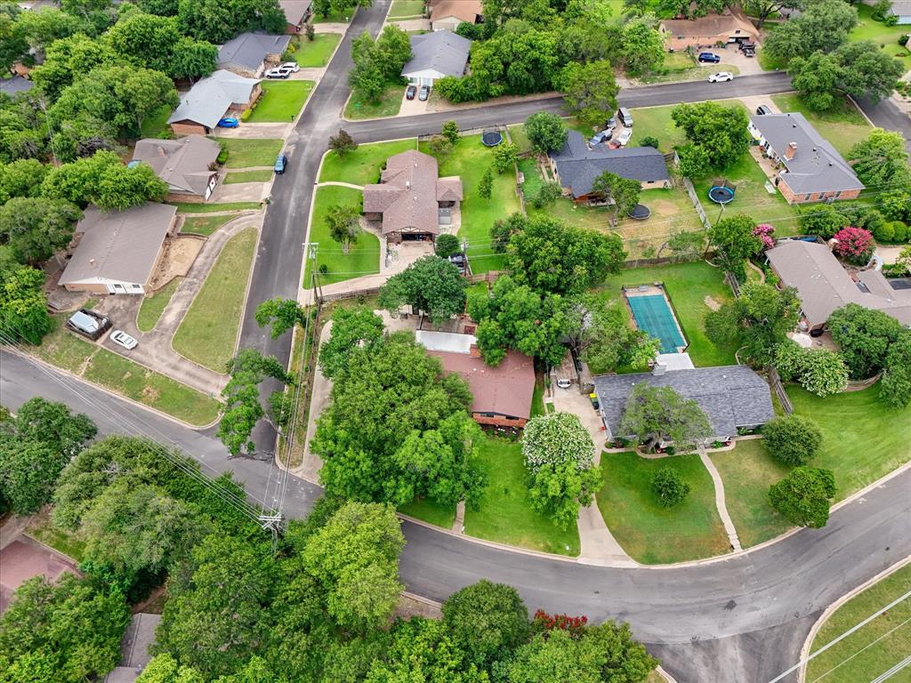 Aerial perspective showcasing a residential neighborhood with mature trees