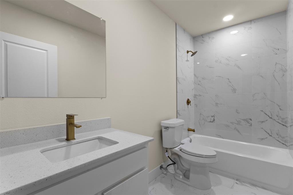 Modern vanity with an integrated rectangular sink and gold-finish faucet