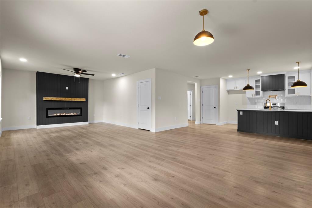 Open concept living area featuring wood-finish flooring