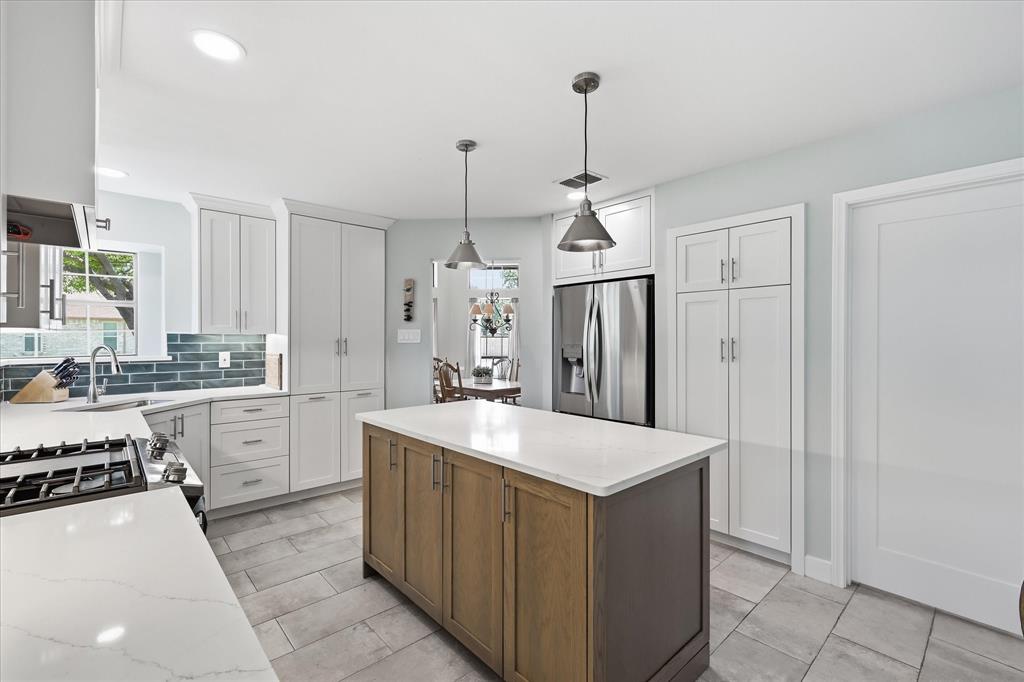 Remodeled kitchen offers an appliance garage and pantry.  42" cabinet uppers allow for much additional storage.  Next to the refrigerator is the built in pantry.