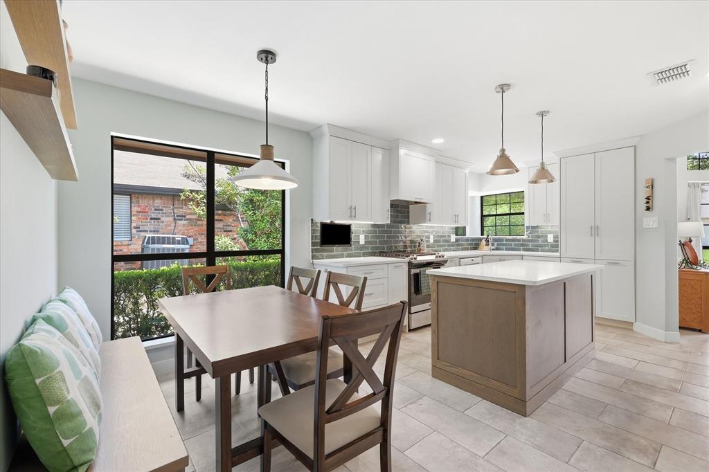 The tall cabinet at the end of the room is the appliance garage.  This is where you will find the microwave.  Great way to keep your countertops clean.