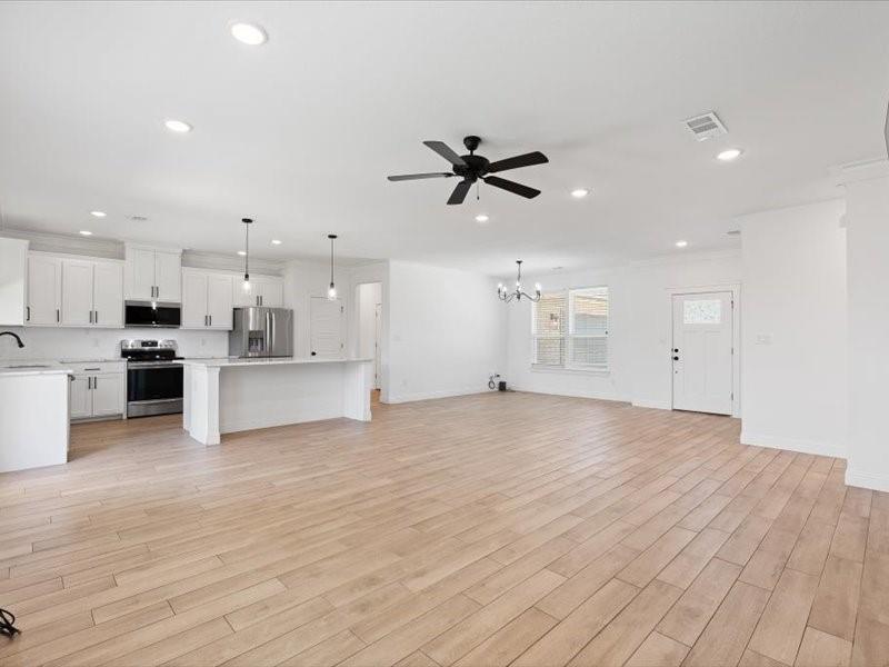 Open-concept living space featuring wood-finish flooring