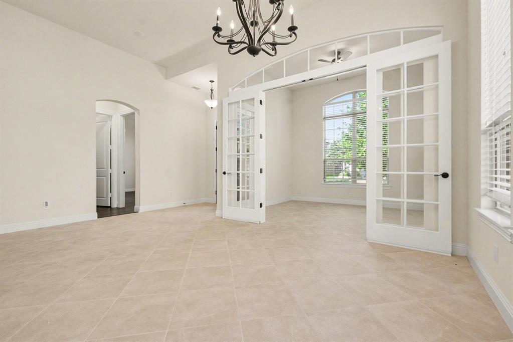 Dining Area leading to Study w French Doors.  Neutral paint throughout.