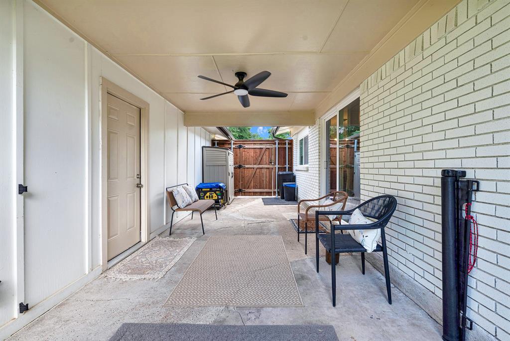 Breezeway between house and garage, currently furnished as TV & entertainment area