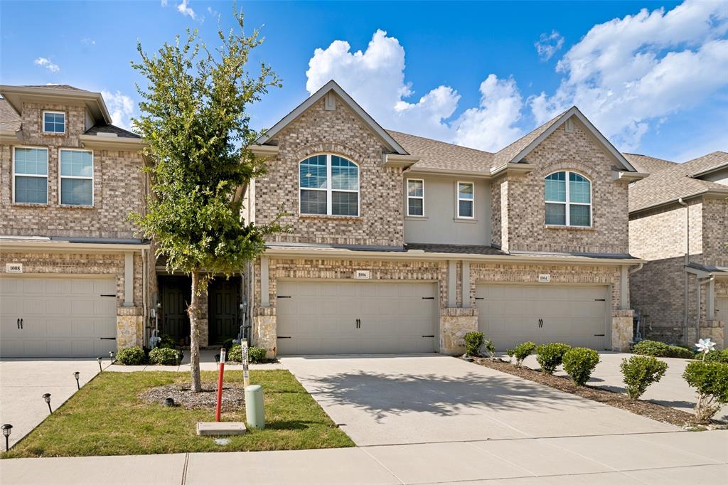 Brick and stone facade townhome with arched window accents