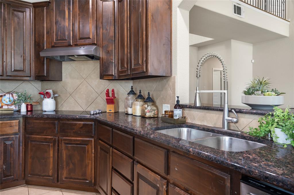 Dark cabinetry and granite throughout.