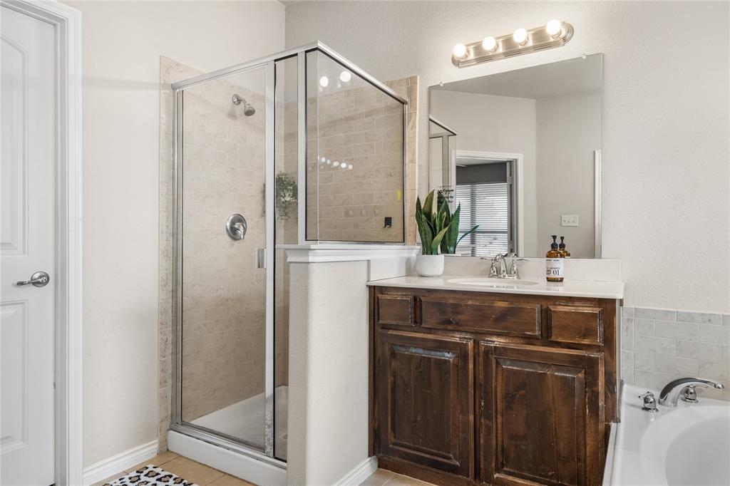 Primary bathroom features two vanities and sizable walk-in closet.