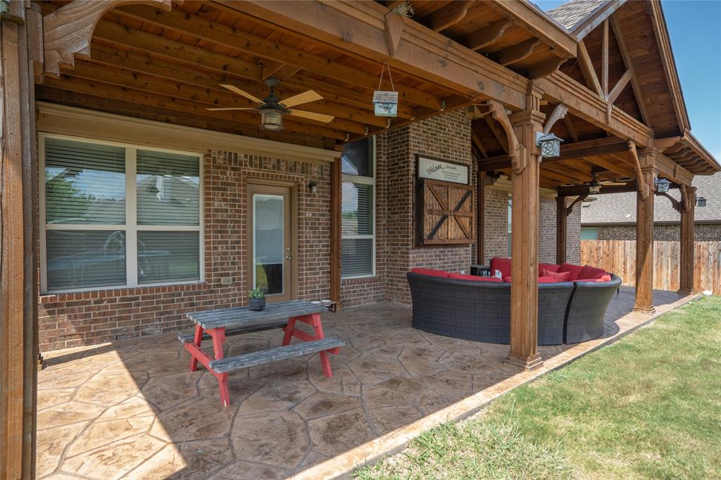 Covered porch area is equipped with TV, perfect for outdoor movies.