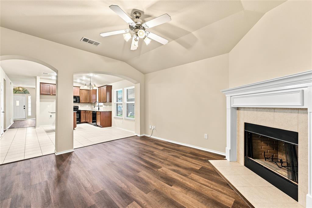 Living area with vaulted ceilings and wood-finish flooring