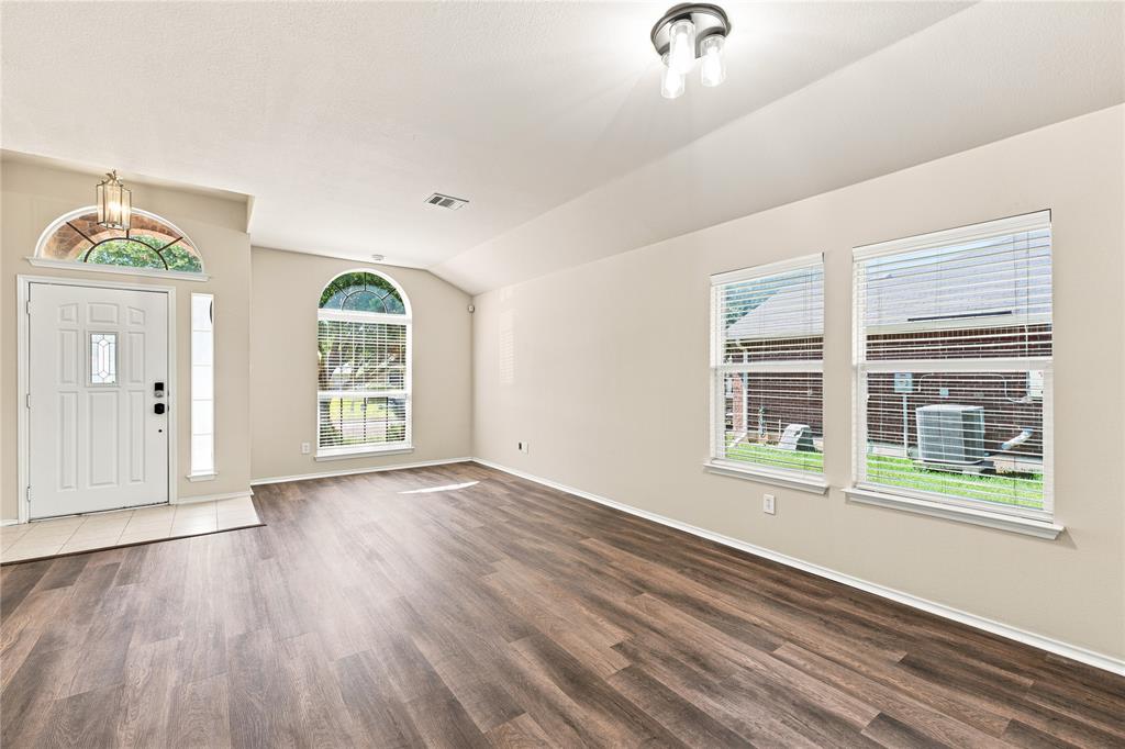 Entry foyer featuring a transom window above the paneled door with sidelight
