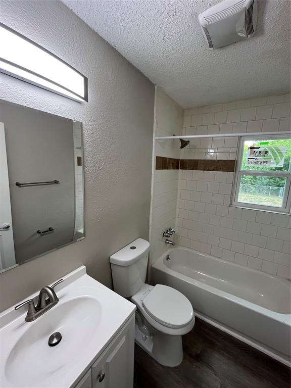 Bathroom featuring a white vanity with integrated sink, brushed nickel faucet, and a large wall mirror