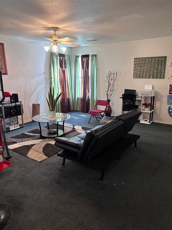 Living space featuring dark carpeting