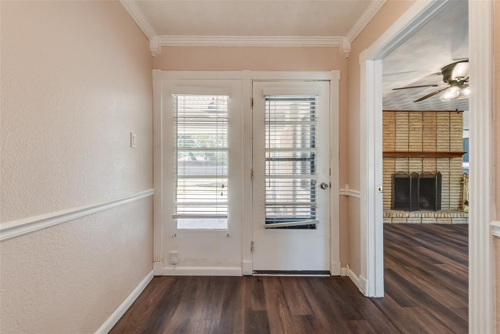 Office off of living area with doors leading to covered patio