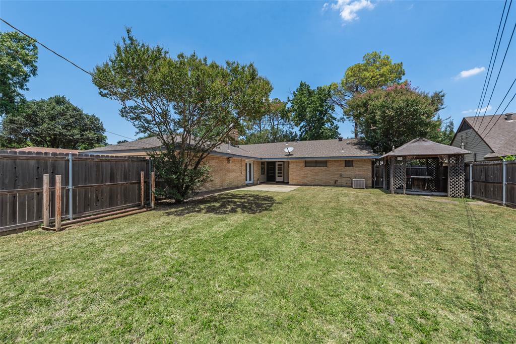 Large patio overlooking wood fenced backyard
