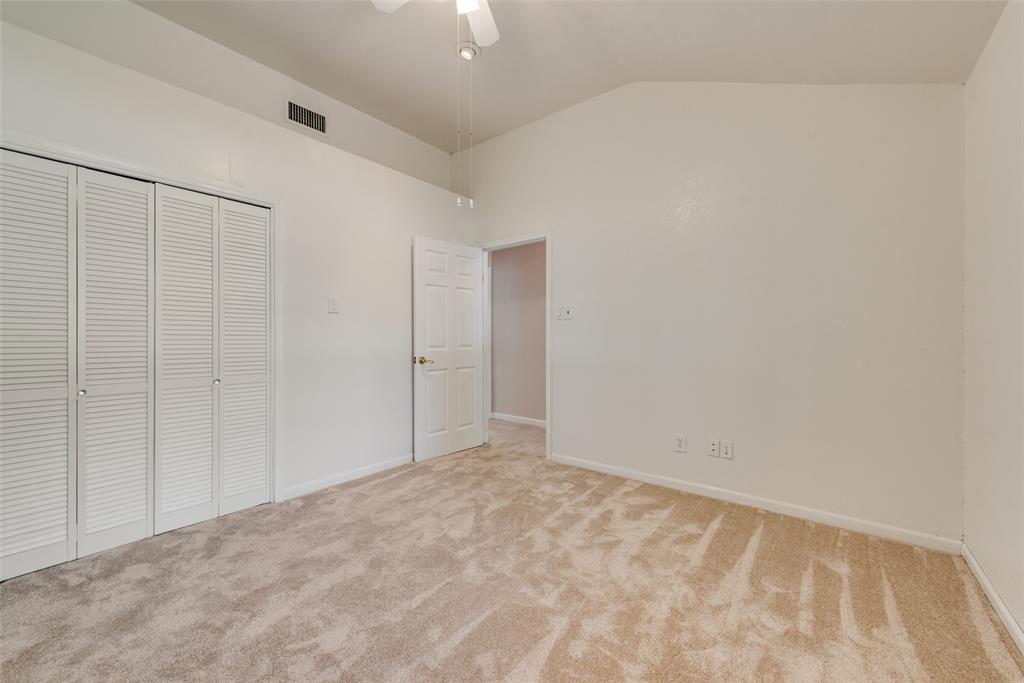Third bedroom featuring a vaulted ceiling
