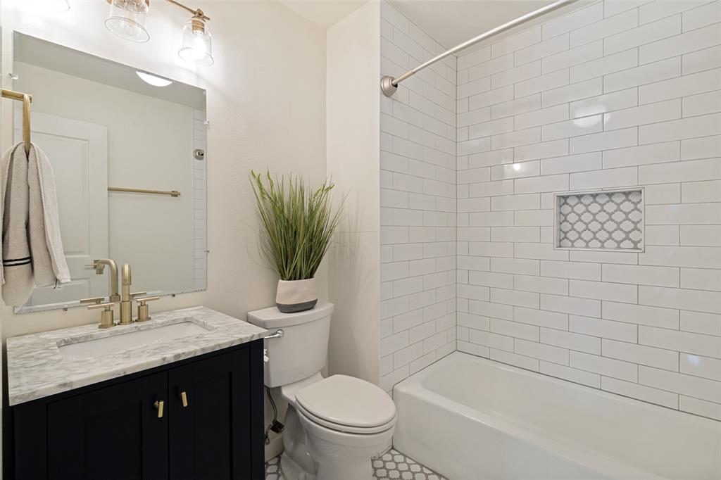 Secondary full bathroom with updated tile