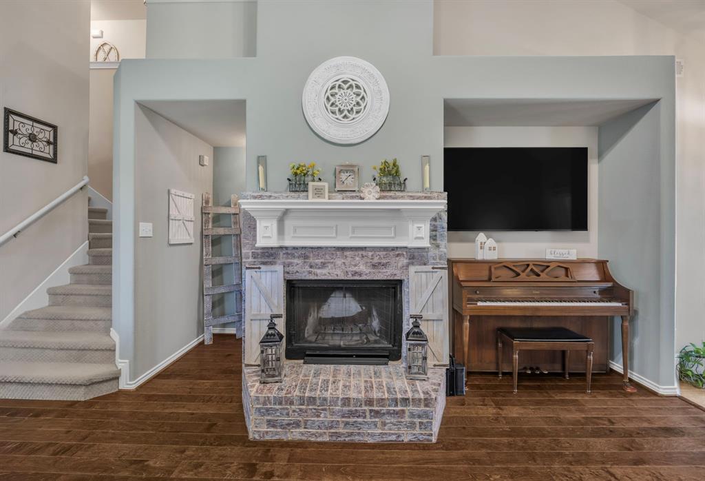 Brick wood burning fireplace with a white mantel.