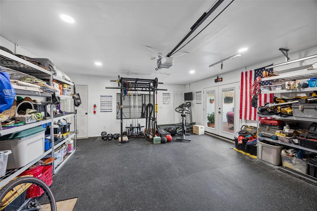 Garage being used as gym with tons of storage