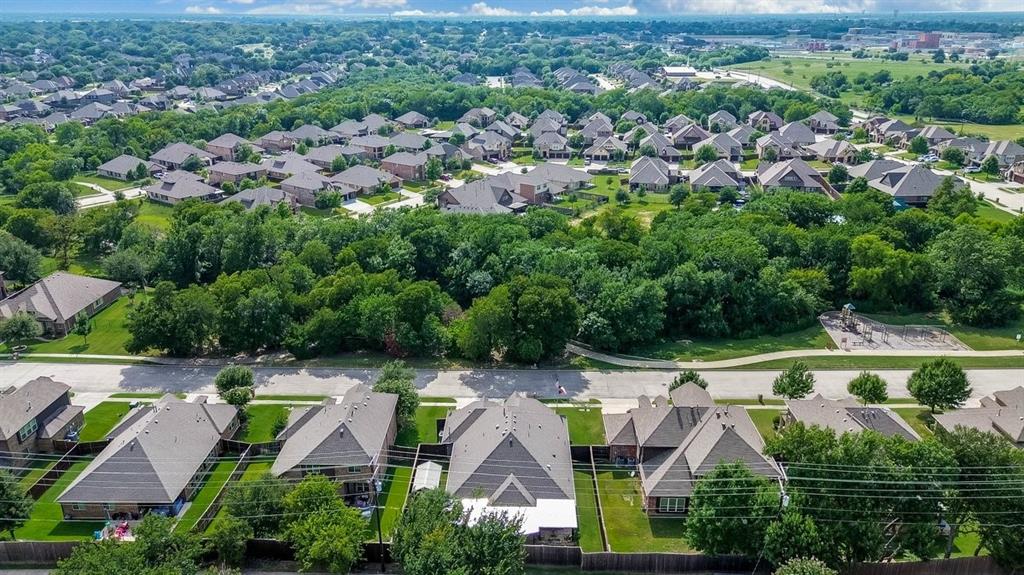 Aerial perspective highlighting residential properties with mature trees and green spaces