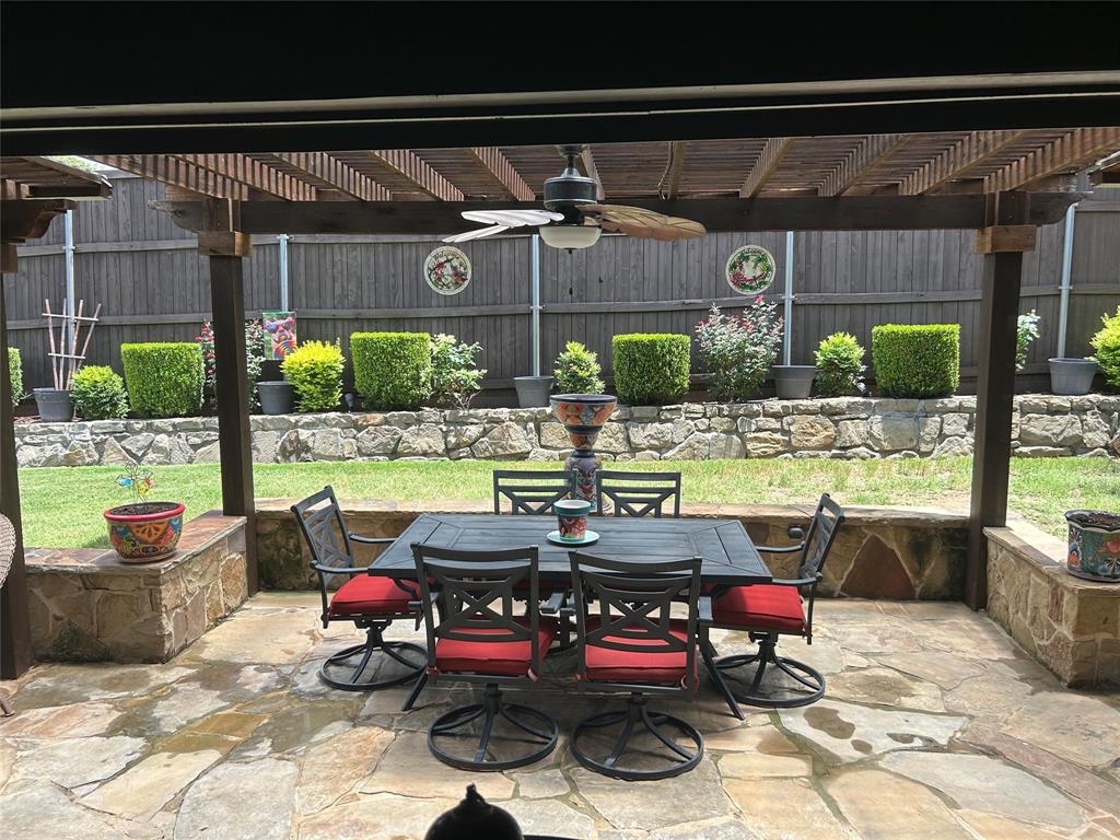 Covered patio featuring a wood pergola and ceiling fan