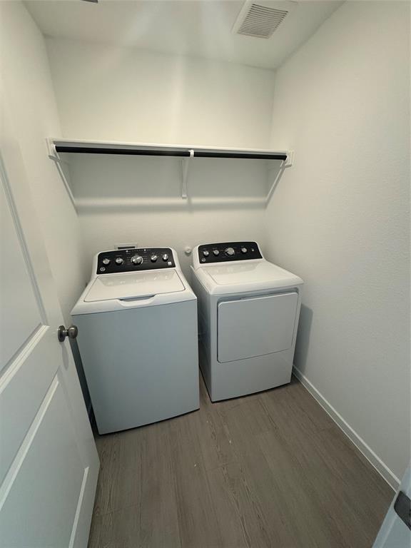 Washroom featuring light wood-style floors and independent washer and dryer