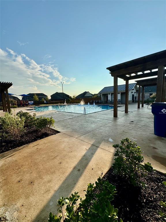 Community pool with a pergola and a patio area