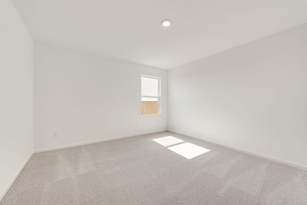 Spare room featuring carpet and baseboards