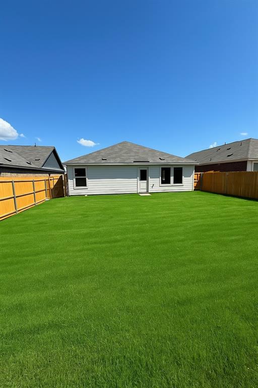 Back of property with a fenced backyard