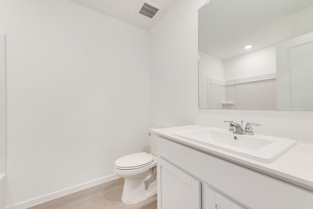 Bathroom with vanity and wood finished floors