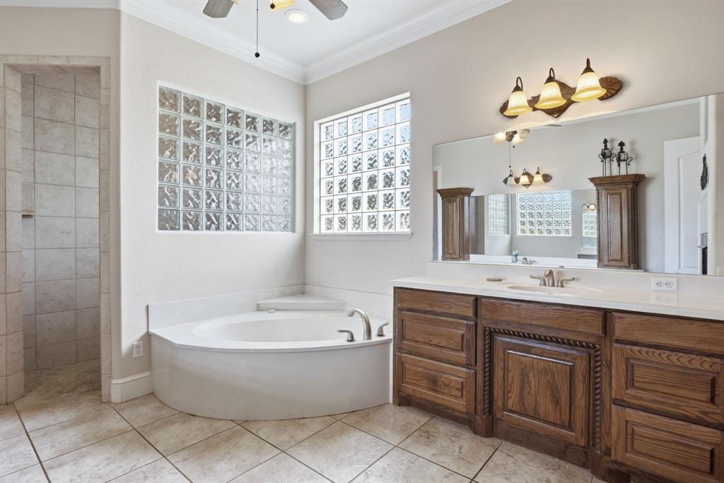 Corner garden tub with surrounding glass block windows