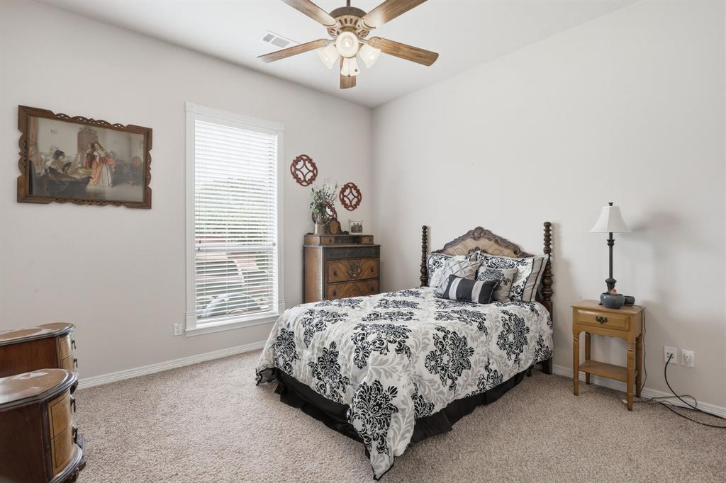 Carpeted room featuring a single window with blinds, a ceiling fan, and light-toned walls