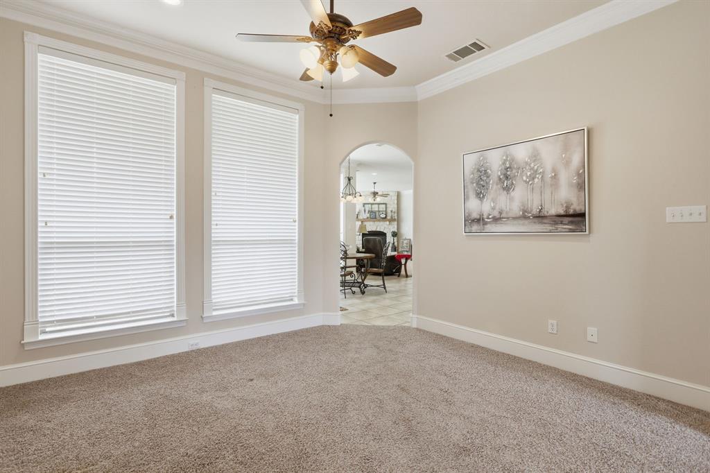 Neutral tone wall paint with white trim, a decorative arched doorway, and recessed lighting