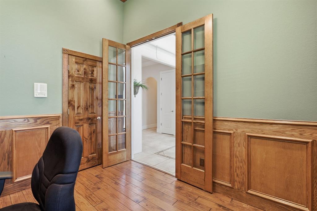 Interior space featuring a wood-finish floor and paneled wainscoting