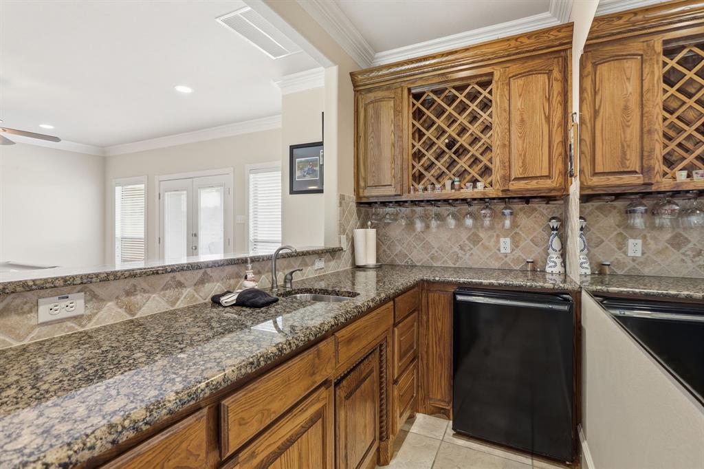 wet bar area with mini fridge and sink