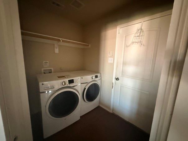 Dedicated laundry area featuring a wall-mounted shelf, utility hookups, and a paneled door Dedicated laundry area featuring a wall-mounted shelf, utility hookups, and a paneled door