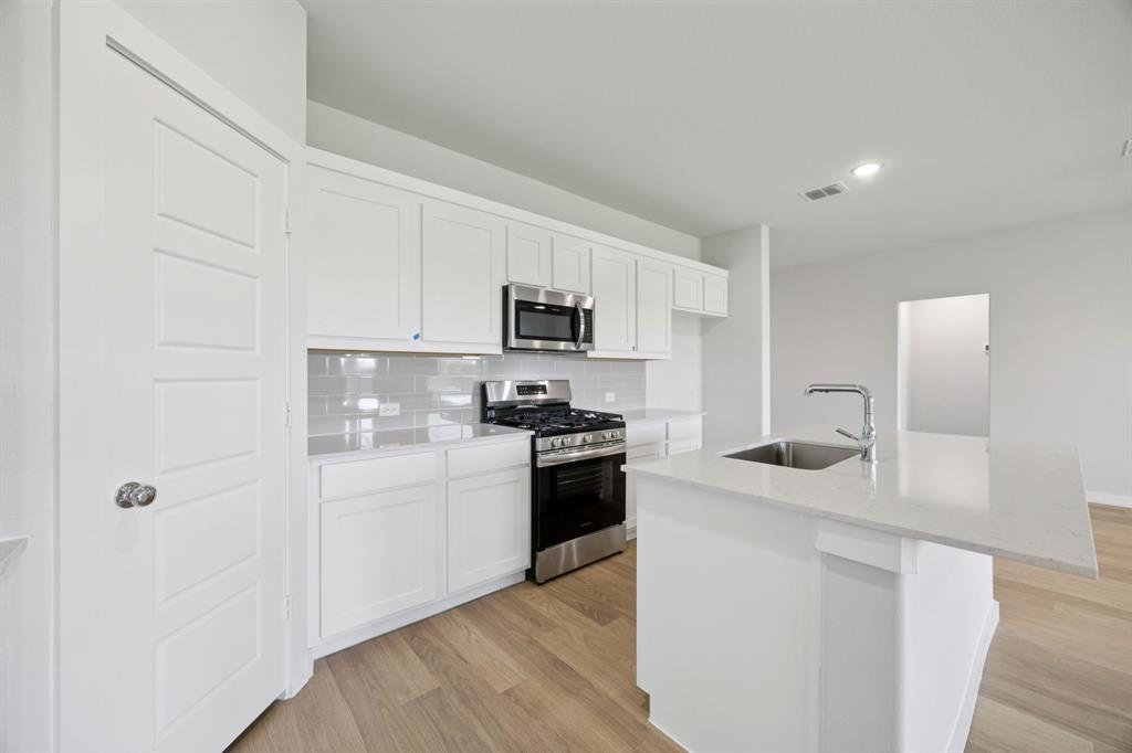Kitchen in the Hadley home plan by Trophy Signature Homes – REPRESENTATIVE PHOTO Kitchen in the Hadley home plan by Trophy Signature Homes – REPRESENTATIVE PHOTO