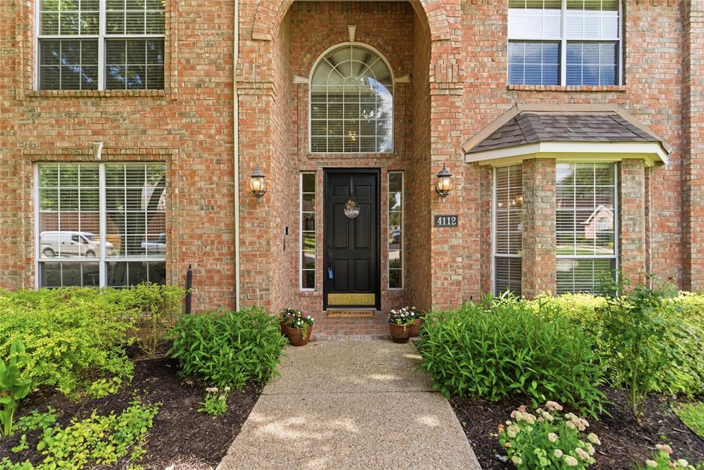 Brick exterior with an arched entry, a black front door, and an arched transom window Brick exterior with an arched entry, a black front door, and an arched transom window