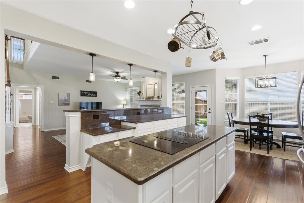 Kitchen island with integrated cooktop and stone-finish countertop Kitchen island with integrated cooktop and stone-finish countertop