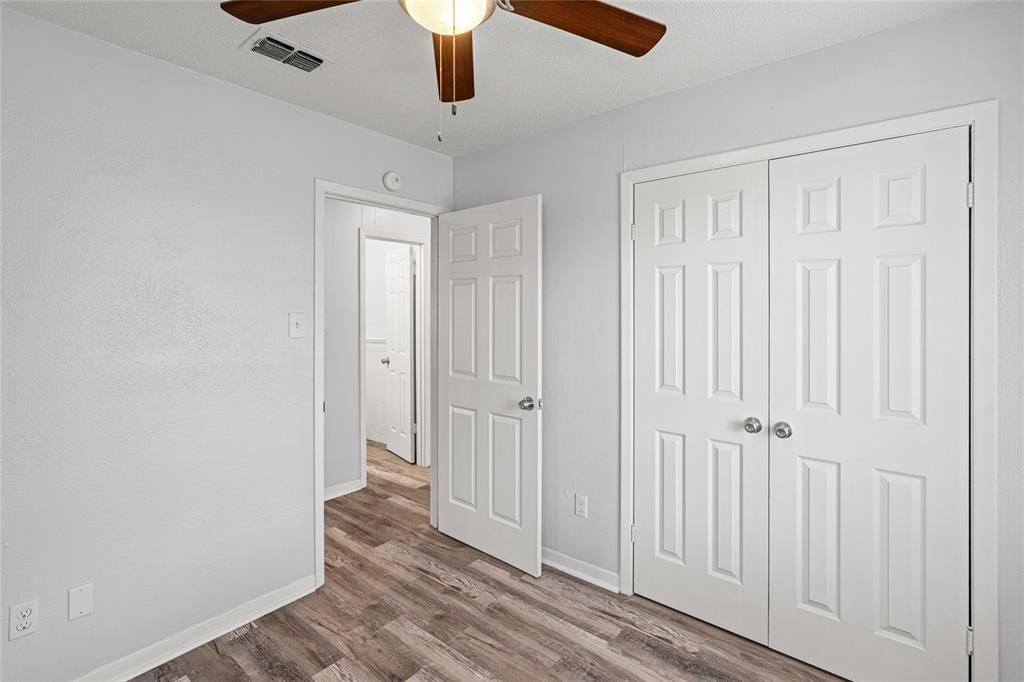 Interior space featuring wood-finish flooring, light grey wall paint, and white trim