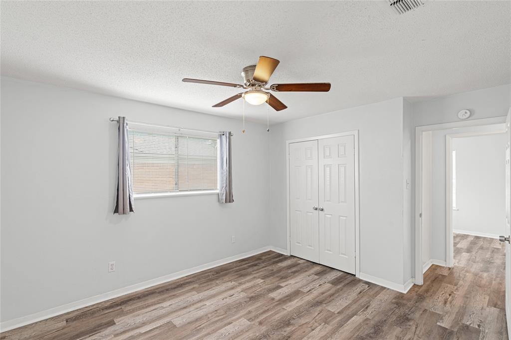 Bright room featuring wood-finish flooring and light-toned walls