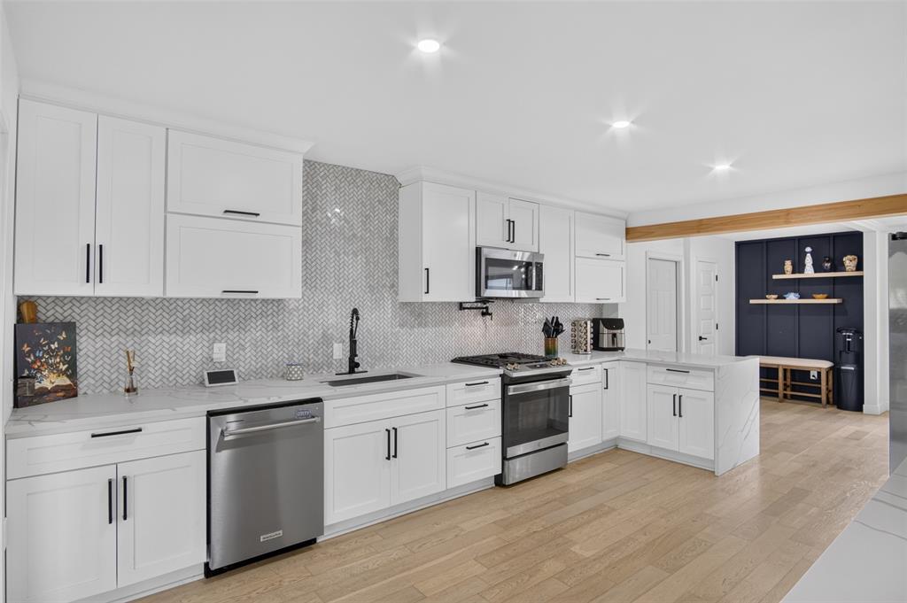 Kitchen has gas range and quartz counters.