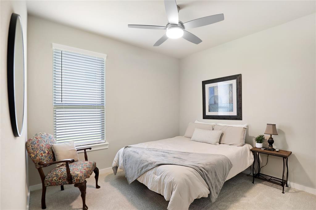 Room featuring a modern ceiling fan with integrated lighting, a window with horizontal blinds, and neutral-toned wall paint