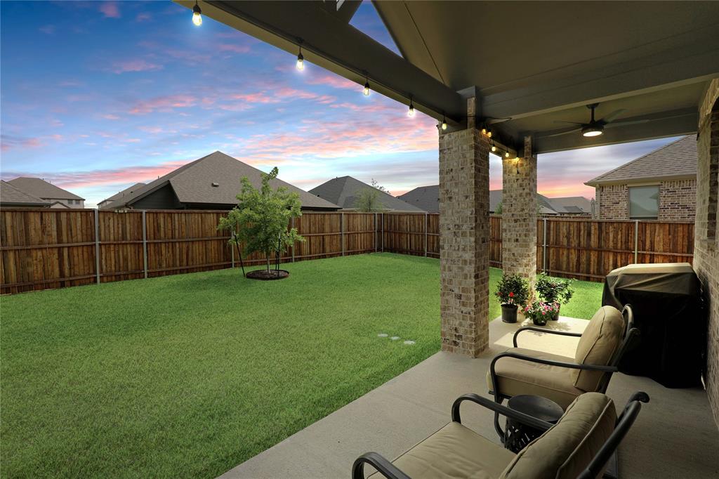 Covered patio with brick columns, recessed lighting, and a ceiling fan