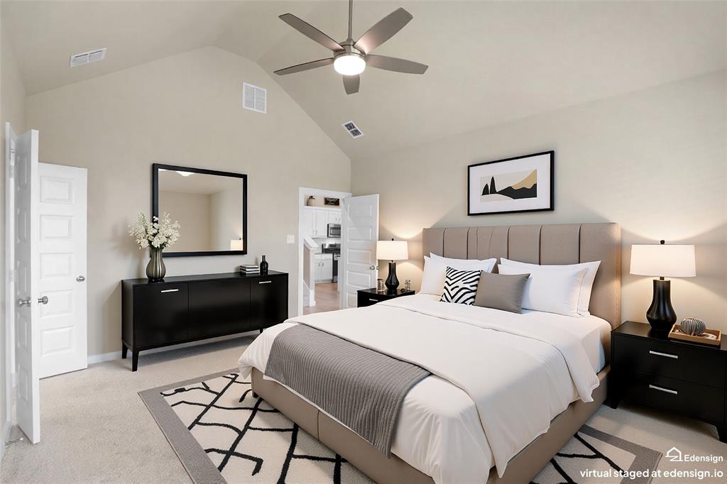 Carpeted room featuring a vaulted ceiling with a ceiling fan
