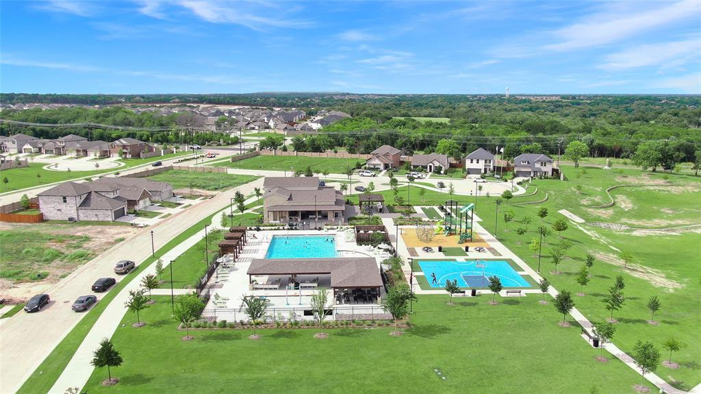 Community recreation area featuring an outdoor swimming pool, covered lounge areas, a playground, and a basketball court