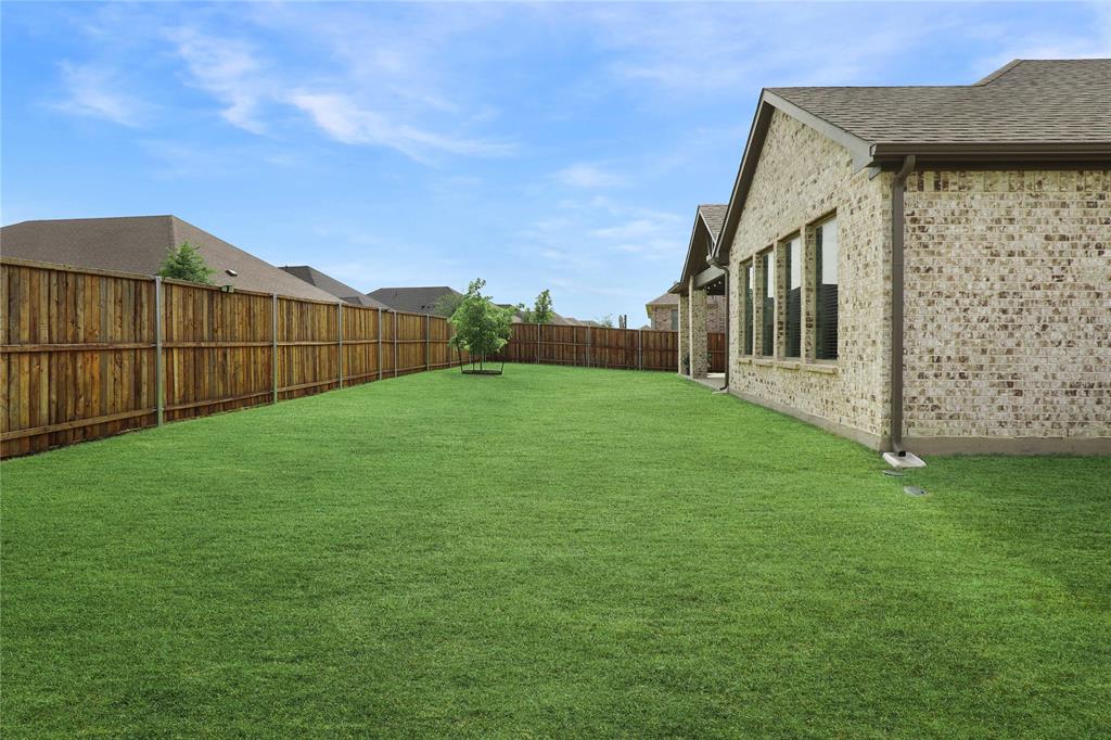 Spacious rear yard featuring an expansive lawn area