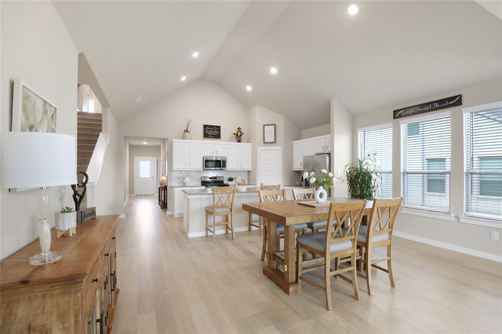 Open-concept living space with a vaulted ceiling and recessed lighting