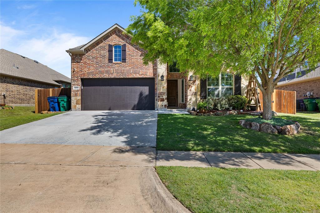 View of front facade with a garage and a front lawn